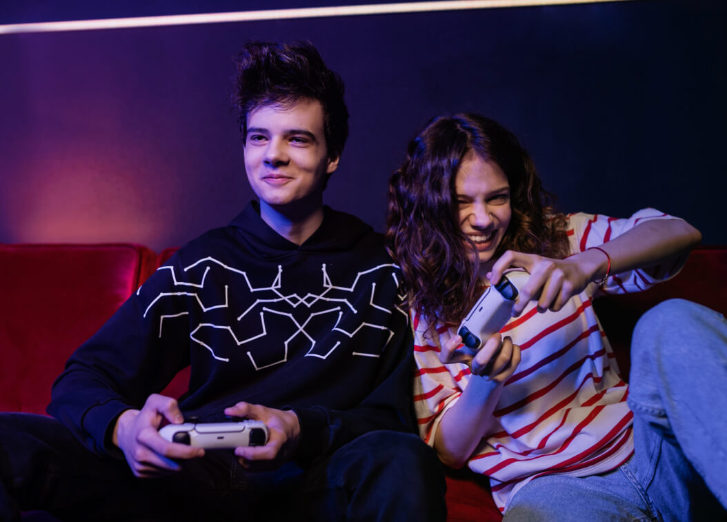 Teenager boy and girl playing video games