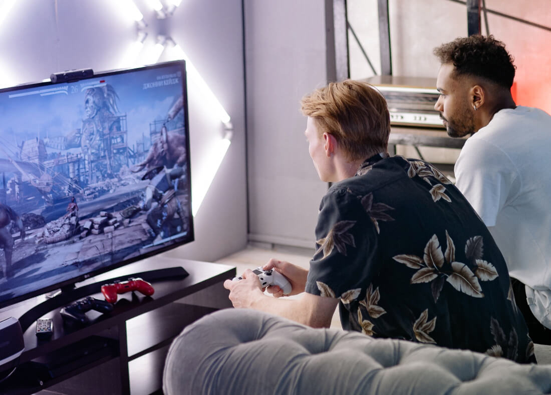 Two men playing a video game on the TV screen