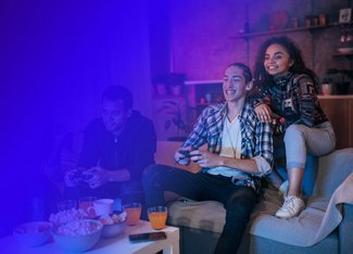 Three people playing a video game and enjoying the atmosphere