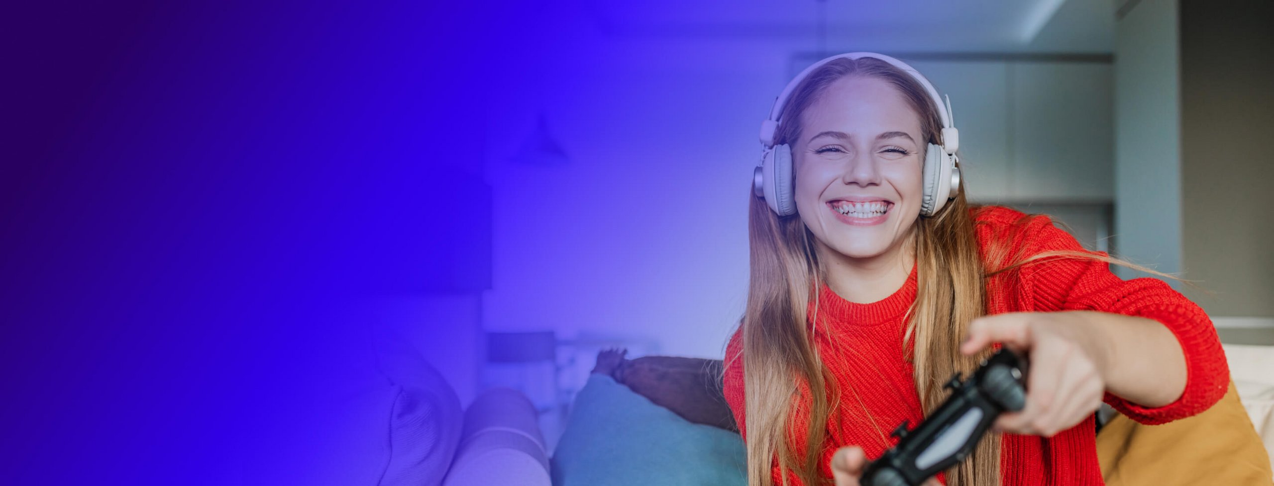 girl playing a game while wearing headphones and holding a game console controller 