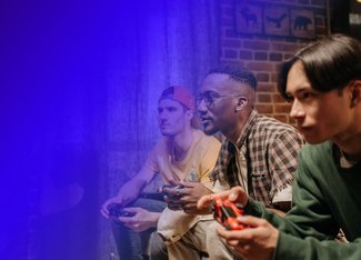 group of 3 male friends playing a video game