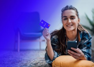 Woman smiling while holding her paysafe card