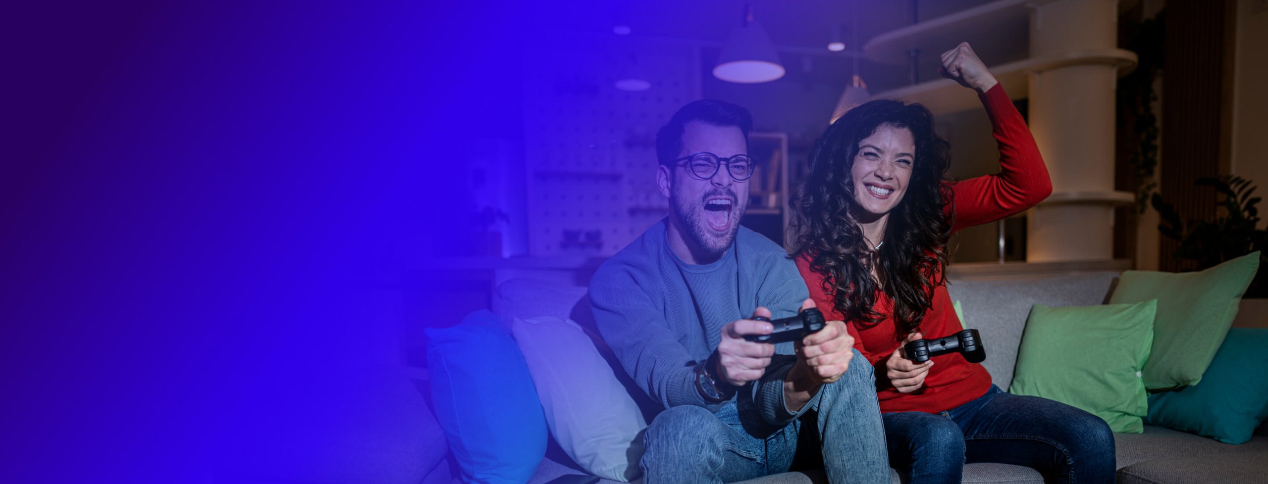 Man and woman playing videogames on the couch