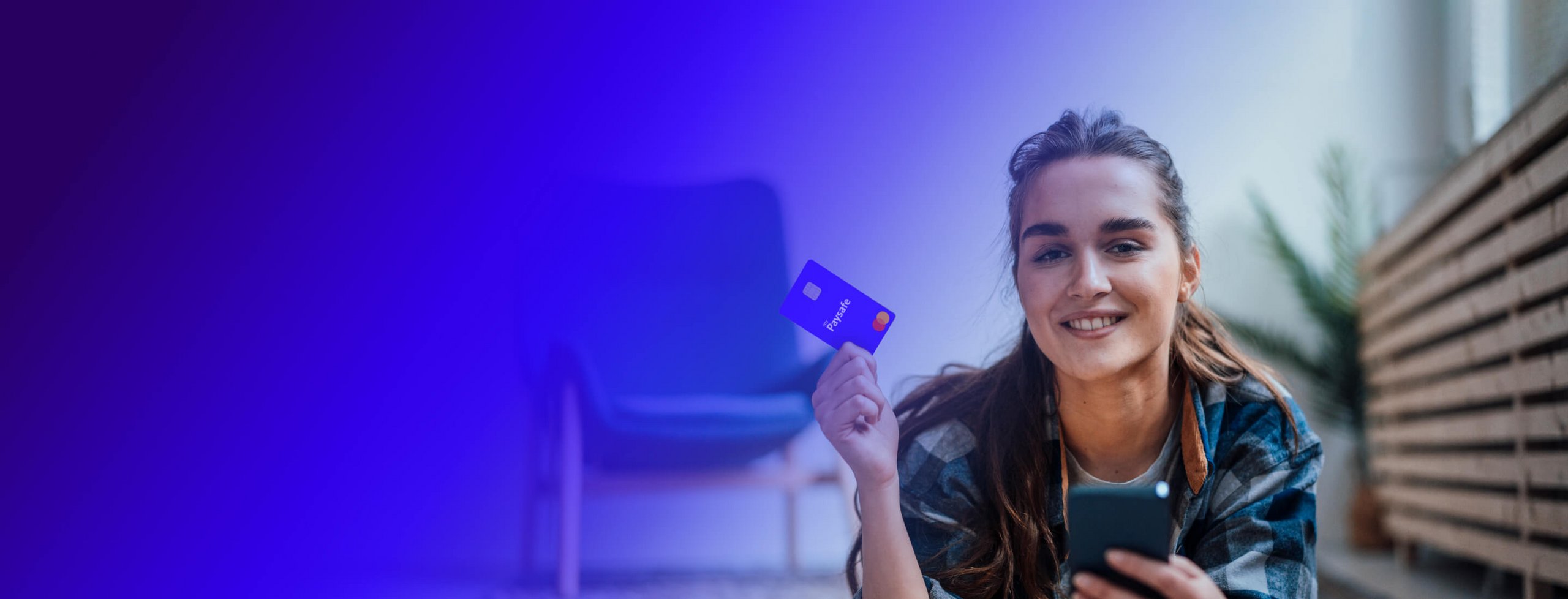 Woman smiling while holding her paysafe card